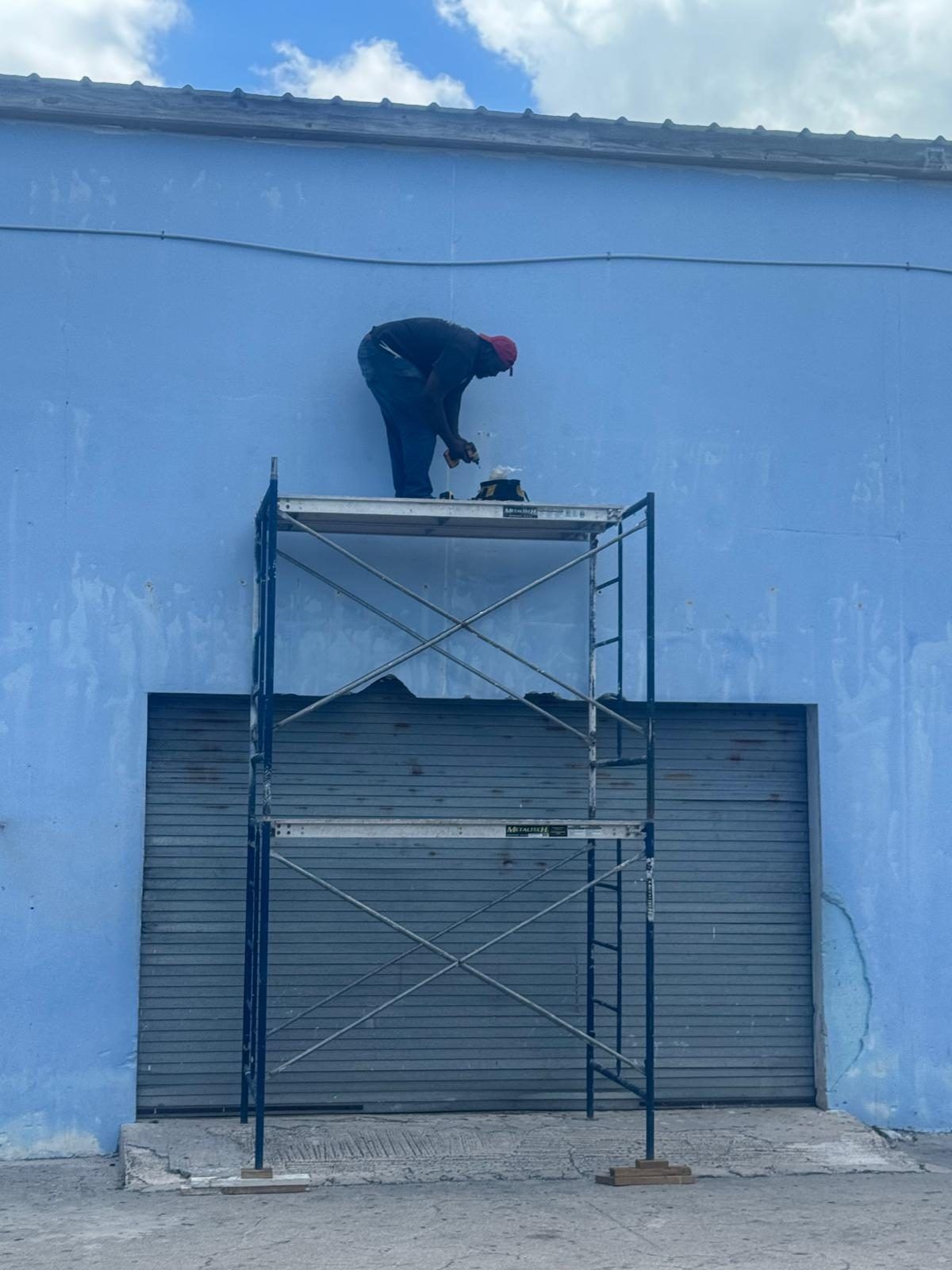 Technician mounting a camera at the roofline